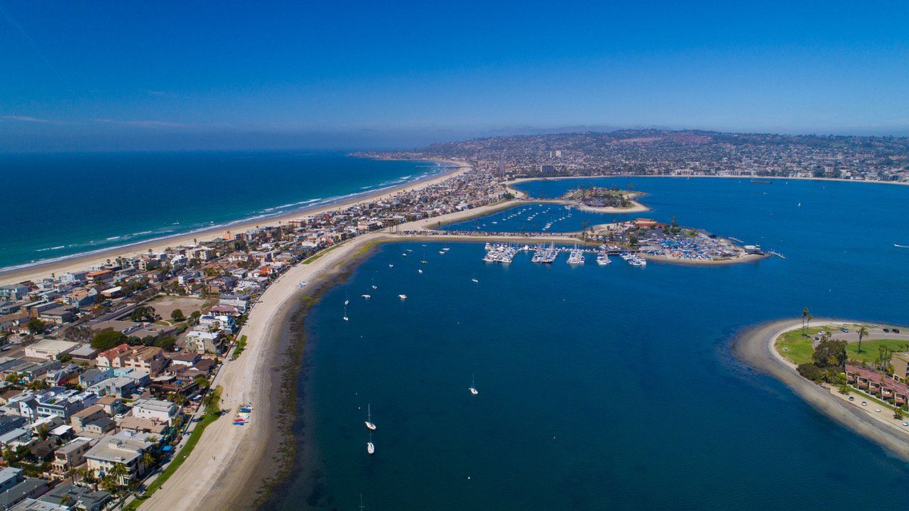 An aerial view of a large body of water surrounded by a city.