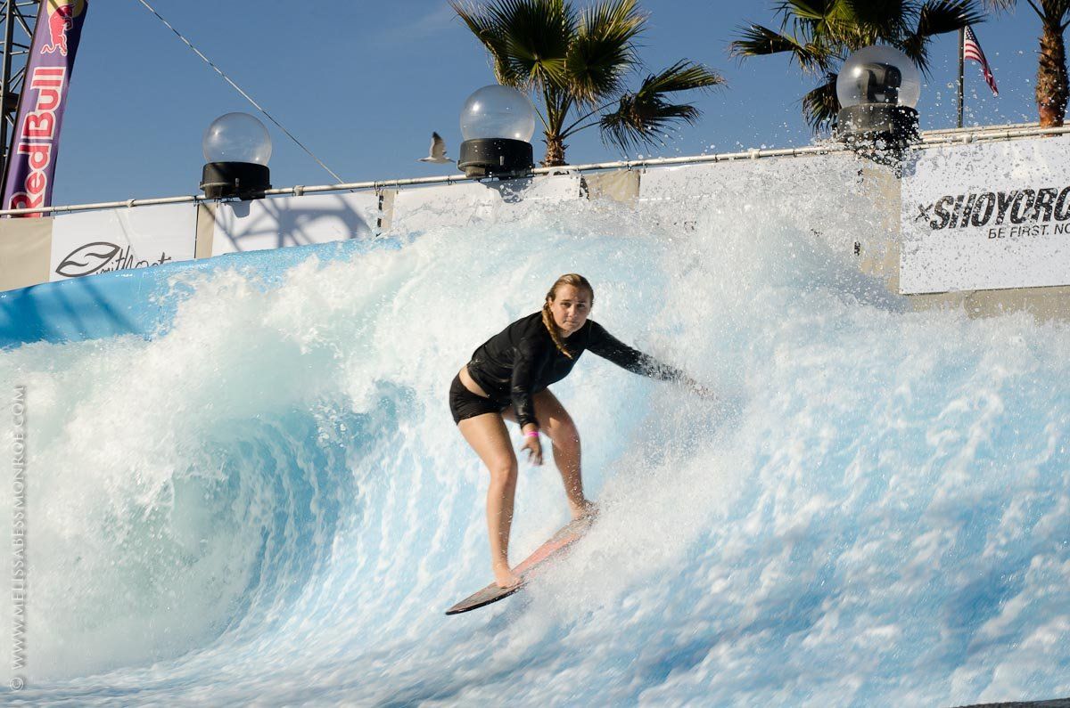 a woman is riding a wave on a surfboard .