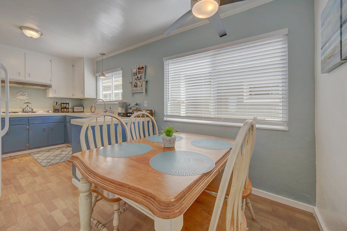 there is a dining table and chairs in the kitchen .