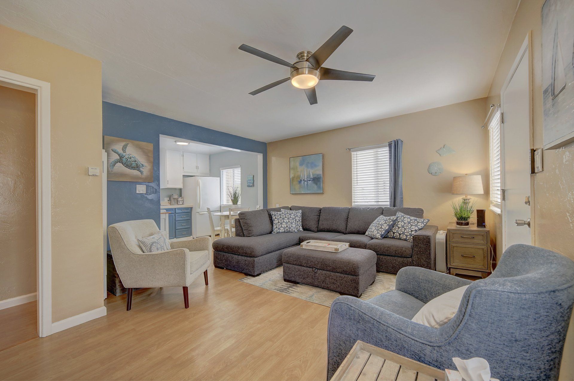 A living room filled with furniture and a ceiling fan.