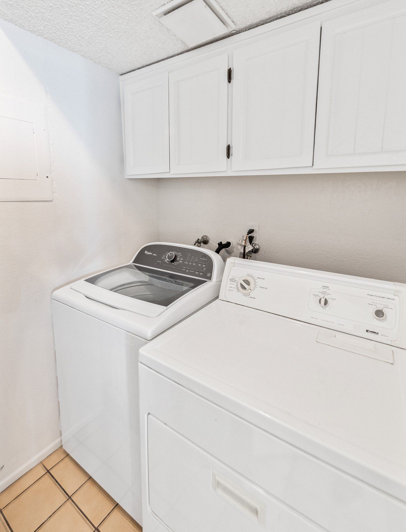 A laundry room with a washer and dryer in it