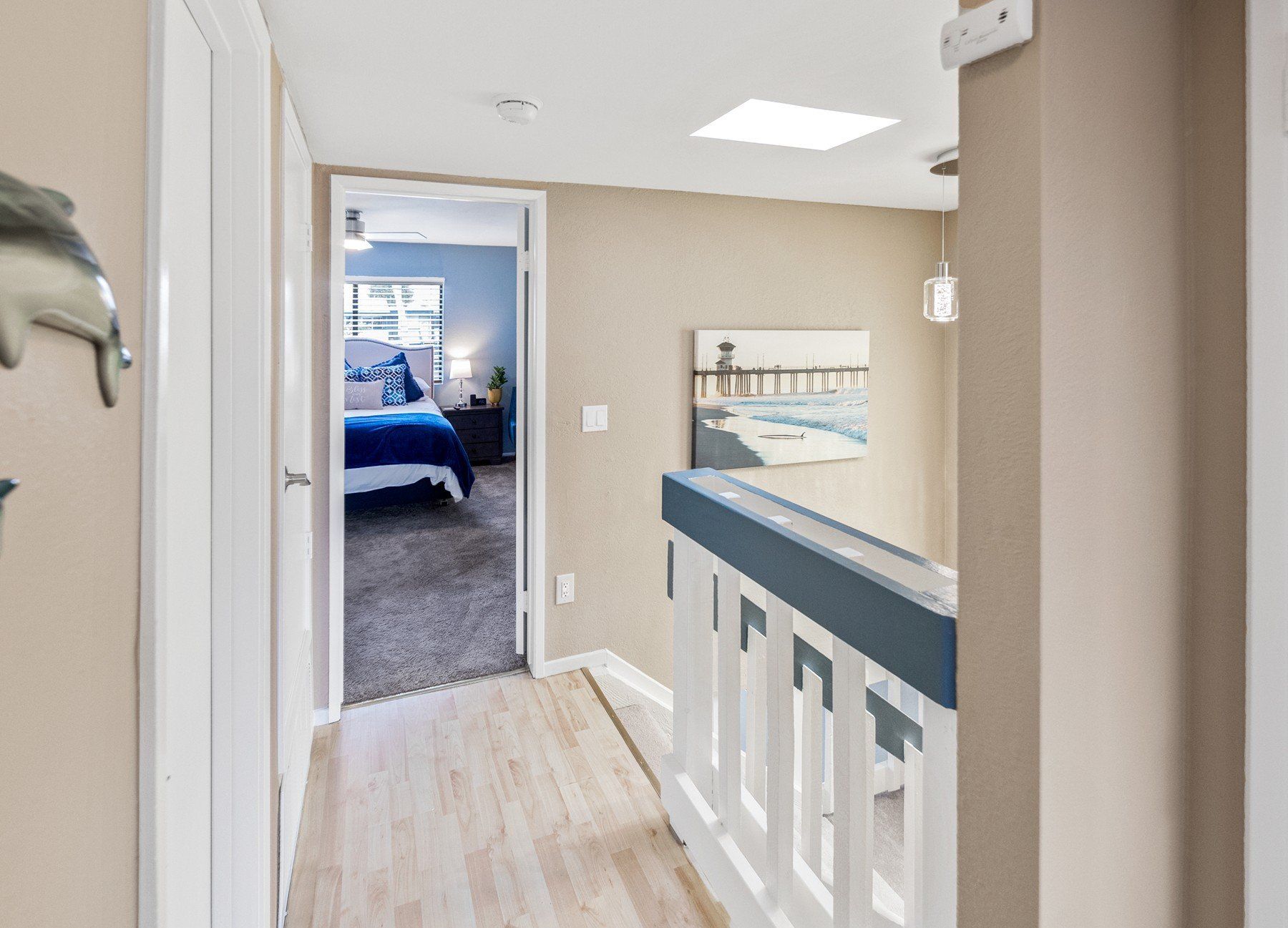 a hallway leading to a bedroom with a dolphin on the wall .