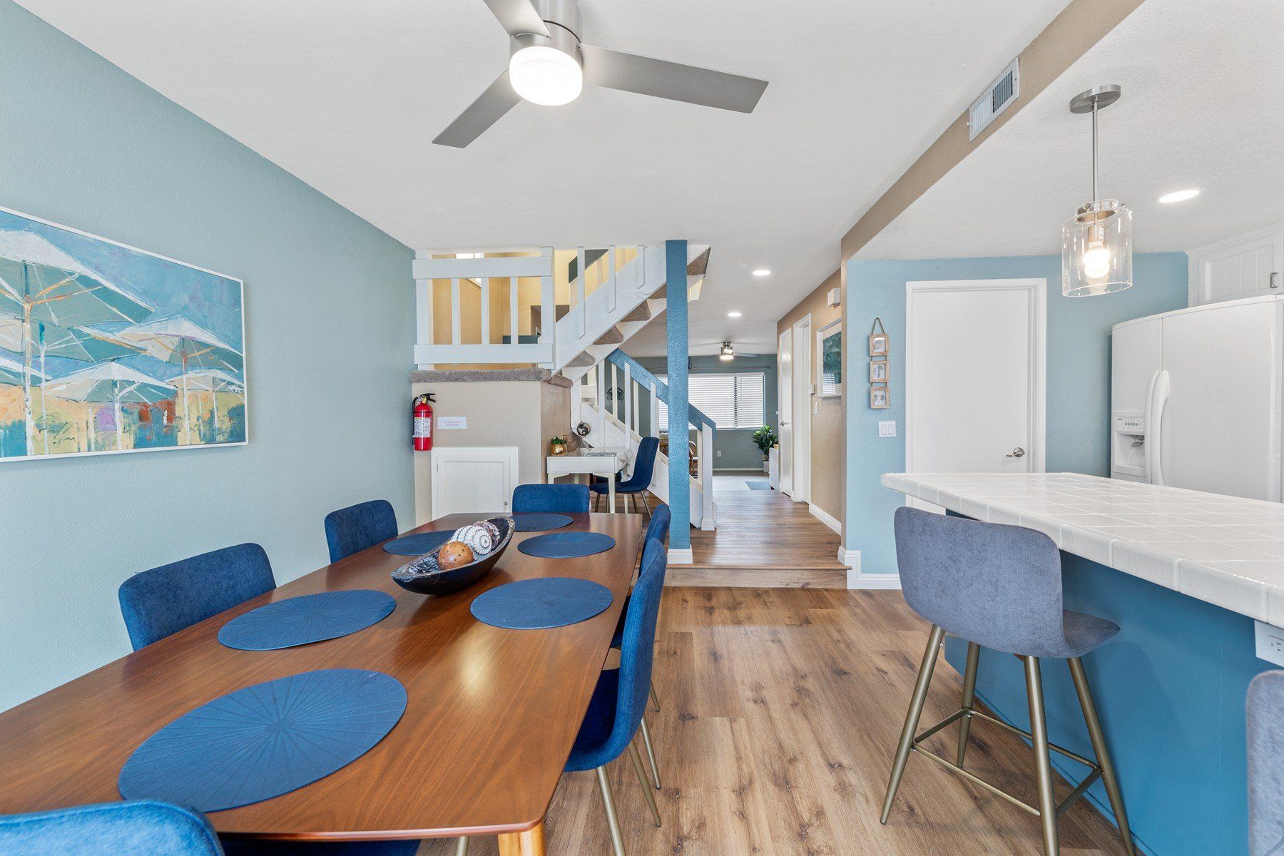 a dining room with a table and chairs and a ceiling fan .