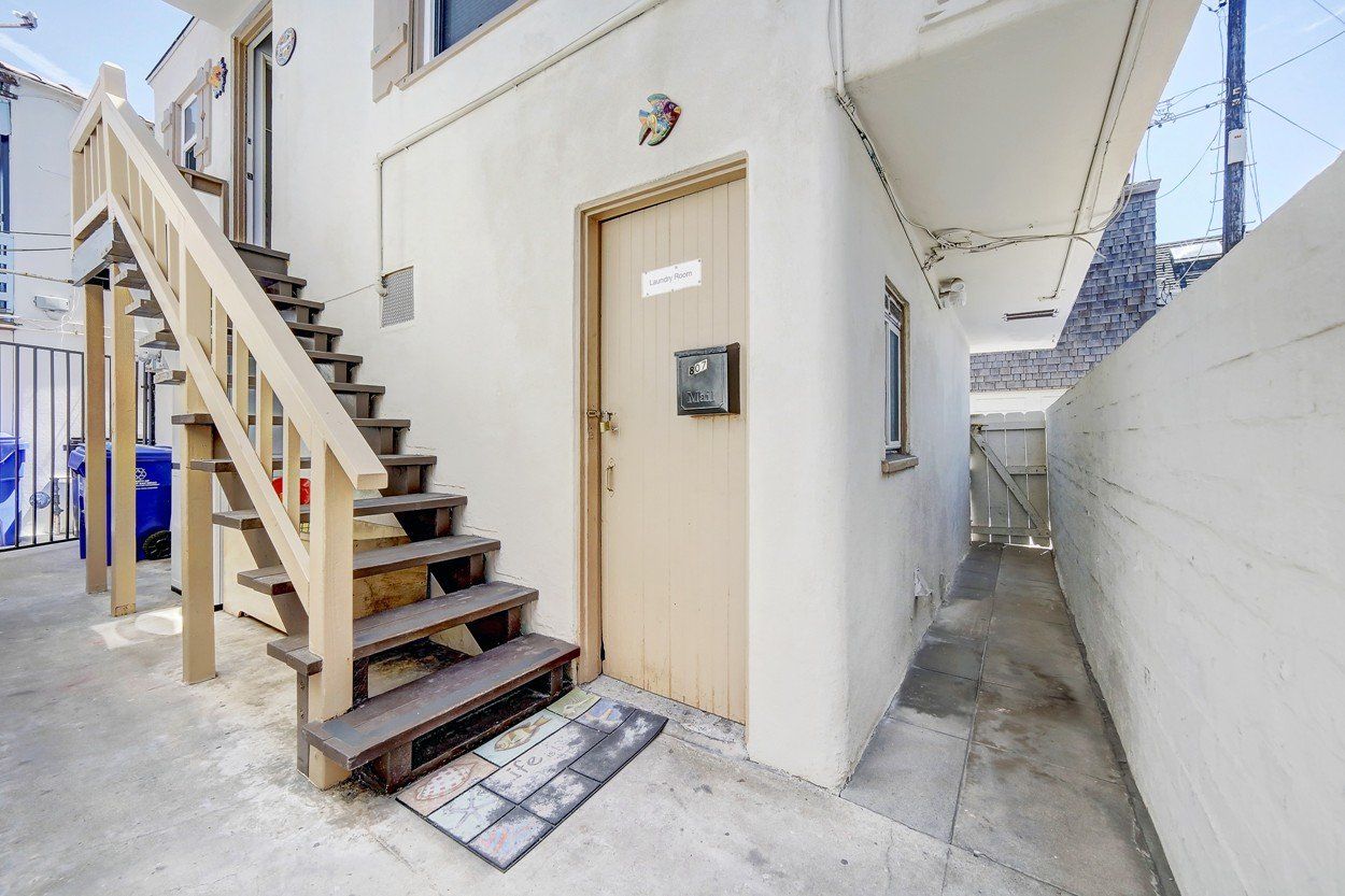 a set of stairs leading up to a door in a building .