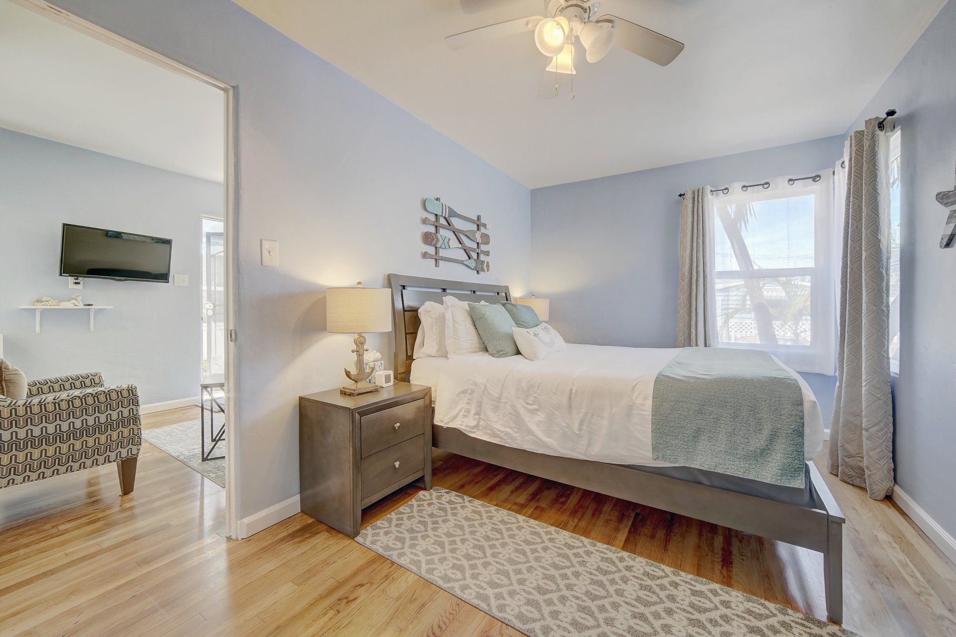 A bedroom with a king size bed and a ceiling fan.