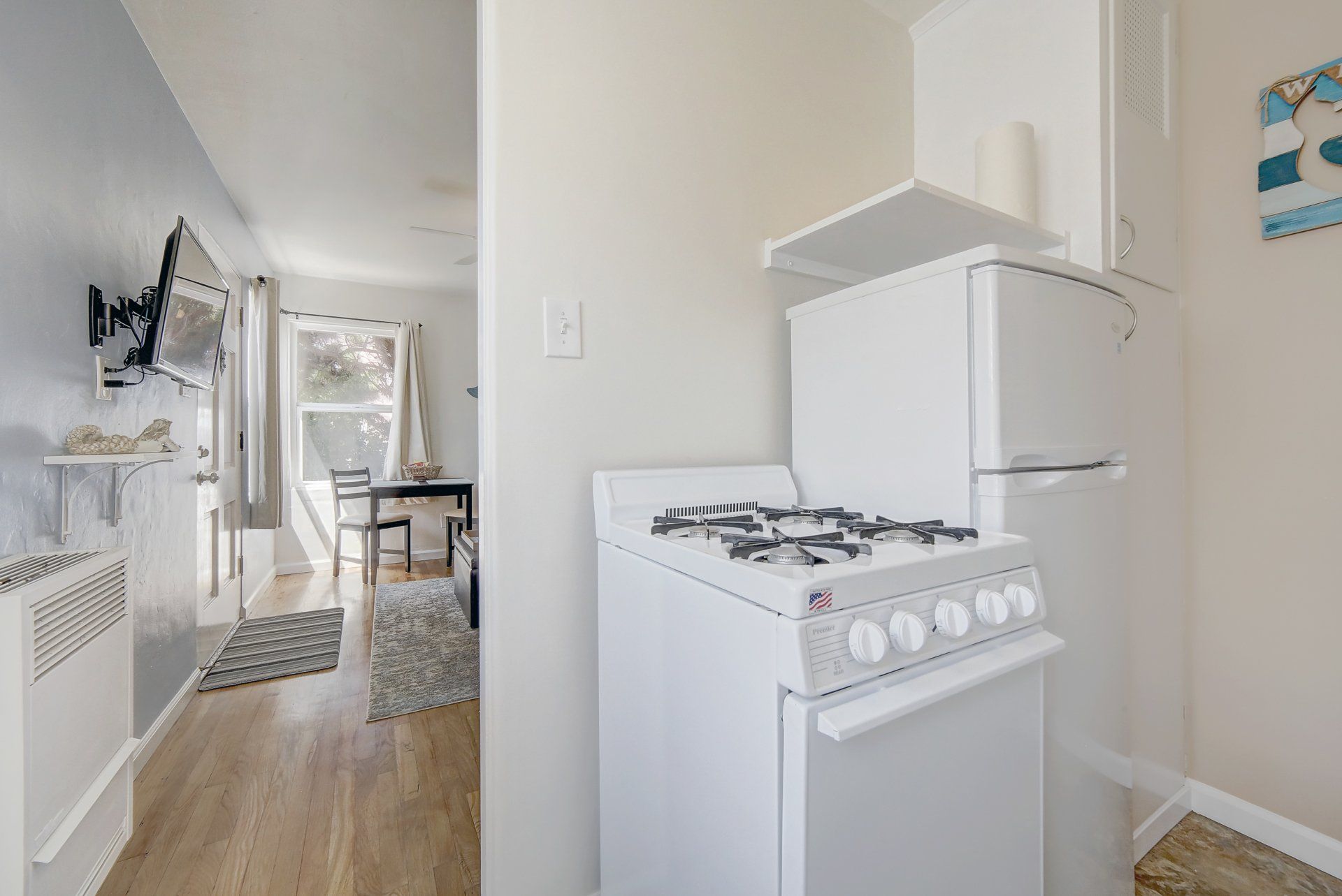 there is a stove and a refrigerator in the kitchen .
