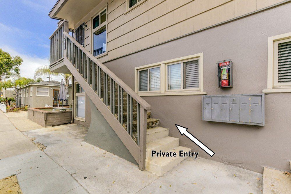 A house with stairs leading up to a private entry