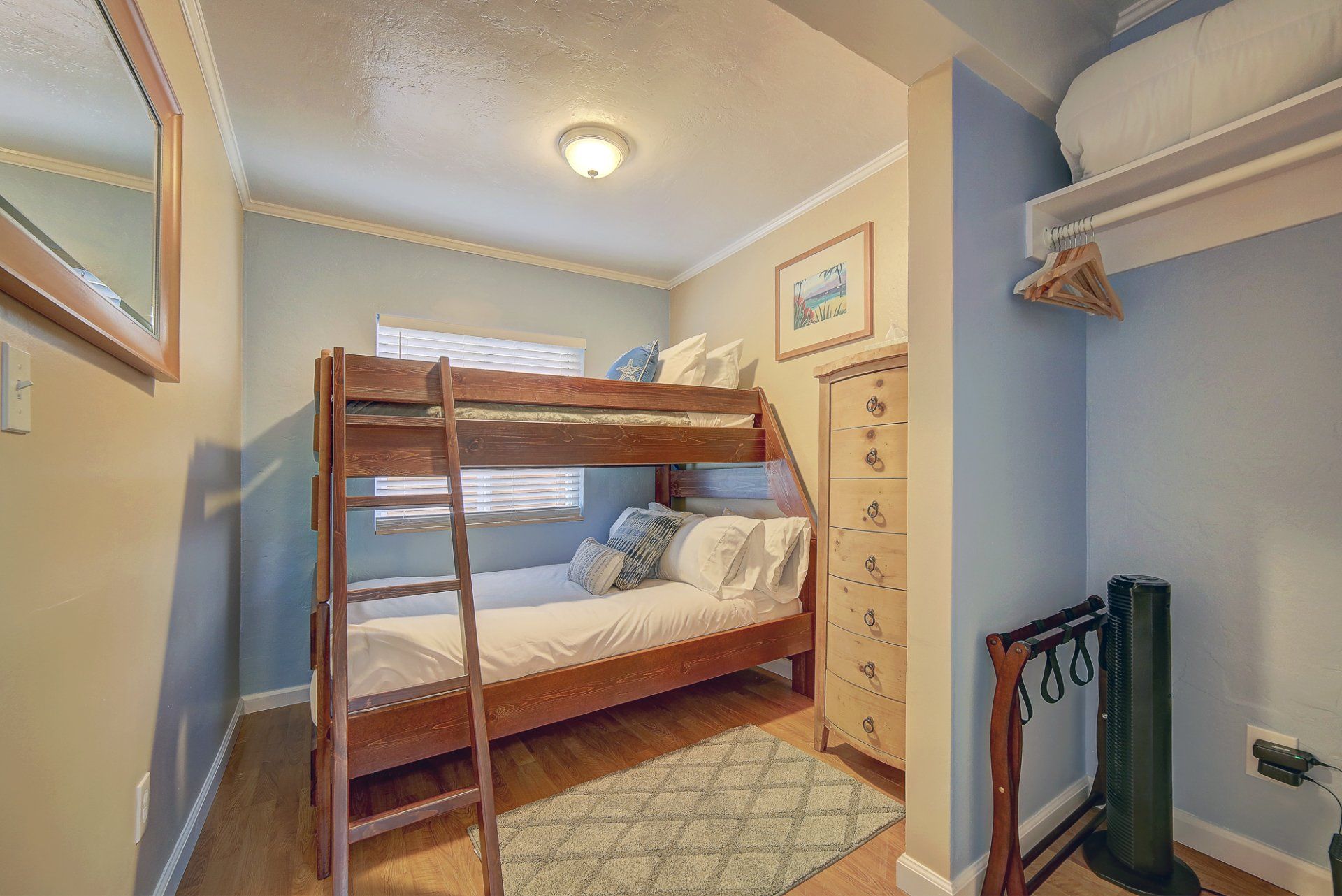 a bedroom with a bunk bed and a dresser .