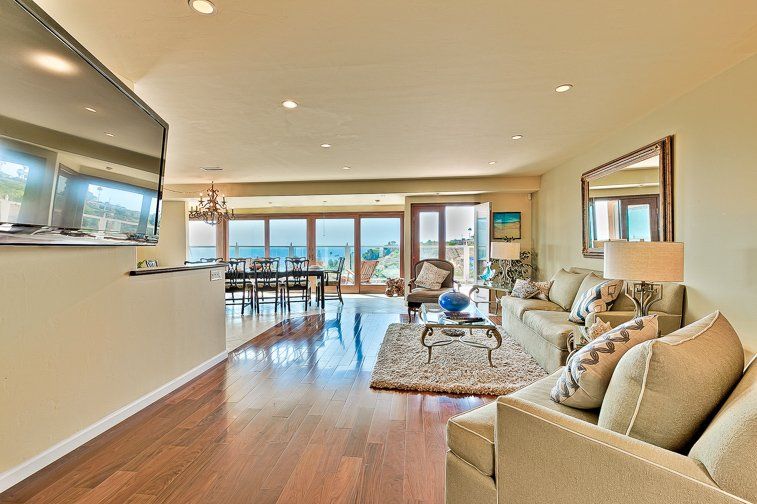 a living room filled with furniture and a flat screen tv .