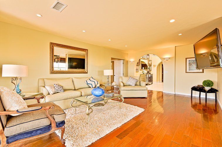 a living room filled with furniture and a flat screen tv .