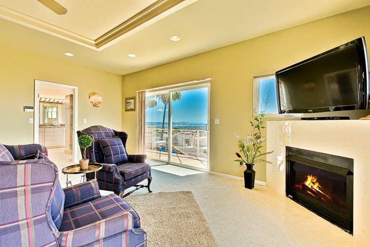 A living room with a fireplace and a flat screen tv.