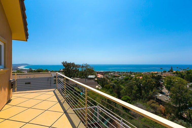 There is a balcony with a view of the ocean.