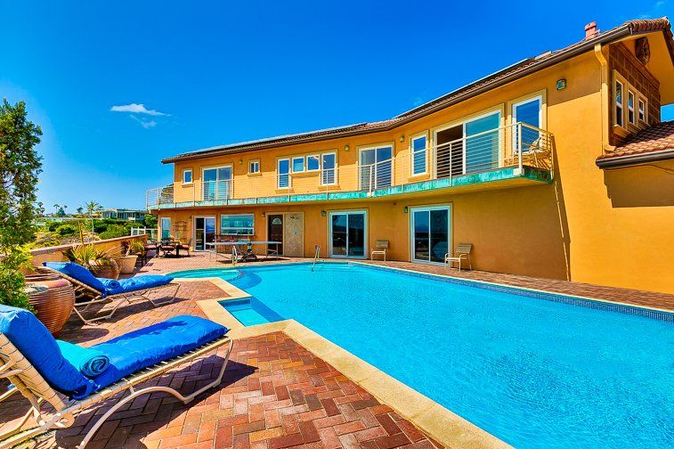 a large house with a large swimming pool in front of it .