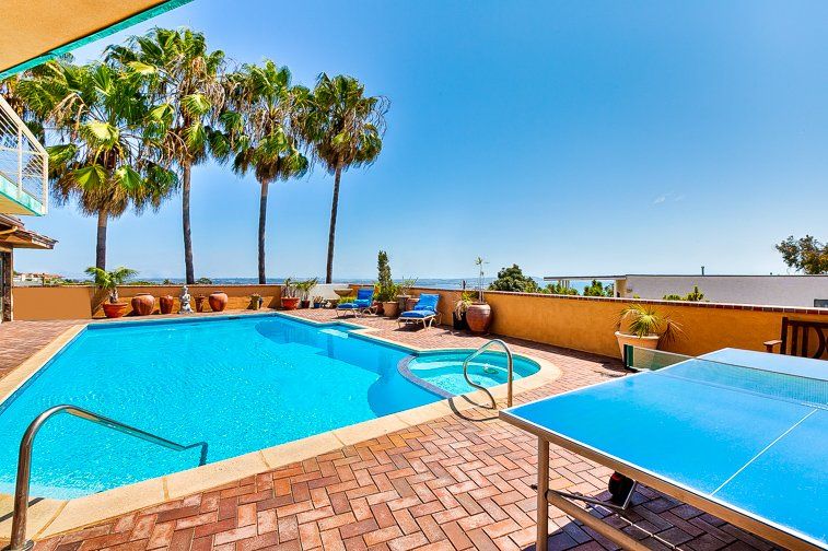 a large swimming pool with a ping pong table in front of it