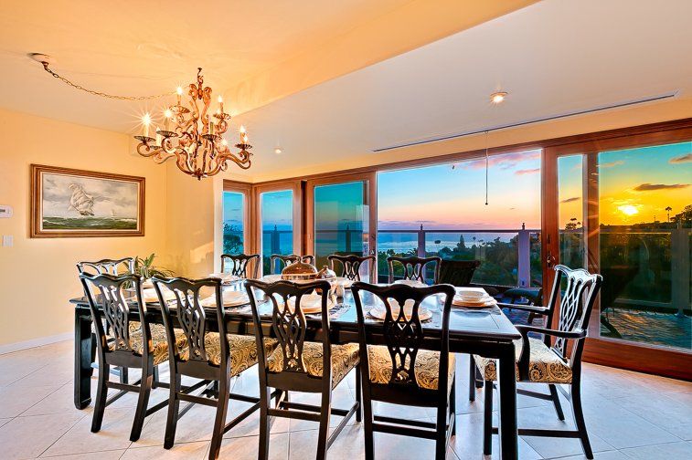A dining room with a table and chairs and a chandelier