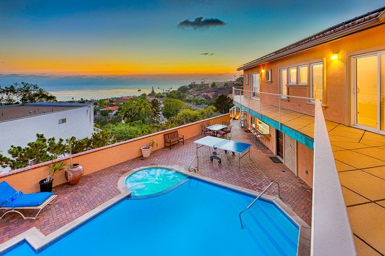 a large house with a large swimming pool in front of it .