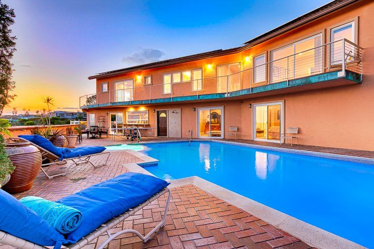 a large house with a large swimming pool in front of it .