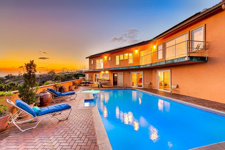 a large house with a large swimming pool in front of it .