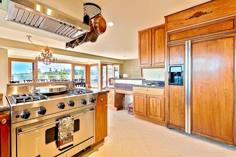 A kitchen with stainless steel appliances and wooden cabinets.