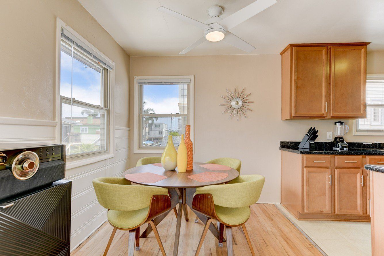 a dining room with a table and chairs and a ceiling fan .