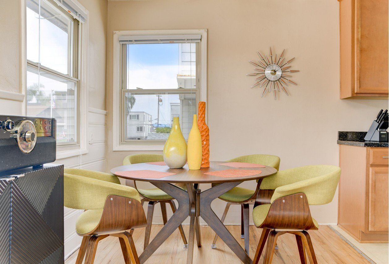 a dining room with a table and chairs and a window .