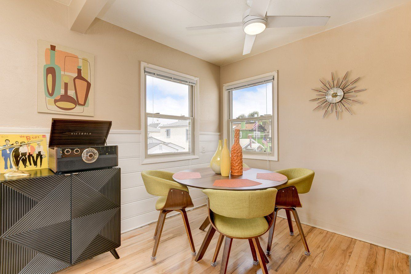 a dining room with a table and chairs and a record player .