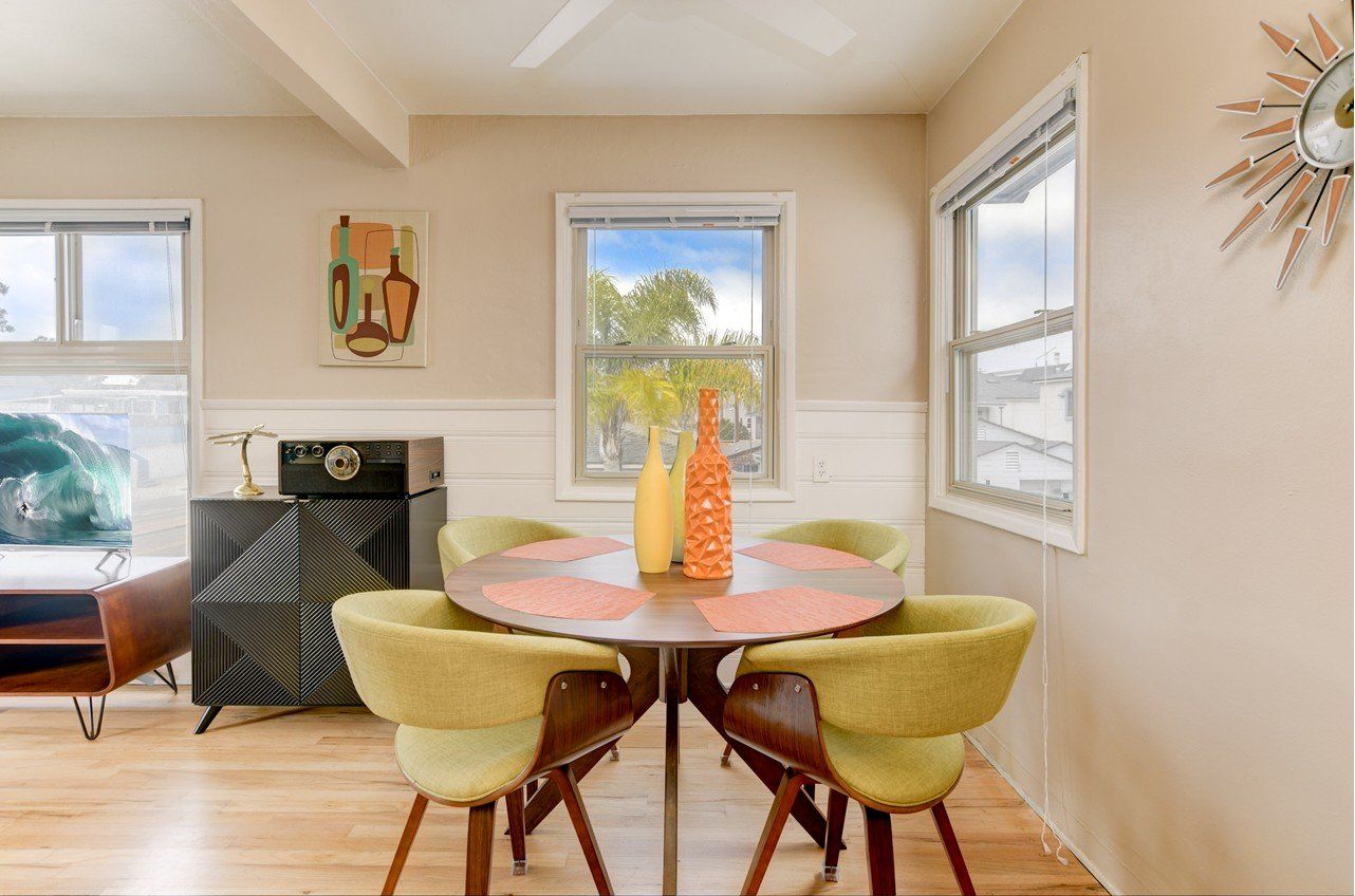 a dining room with a table and chairs and a window .