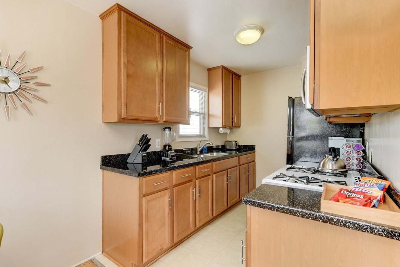 a kitchen with wooden cabinets and granite counter tops