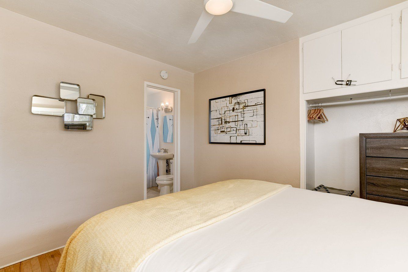 a bedroom with a bed , dresser , and ceiling fan .