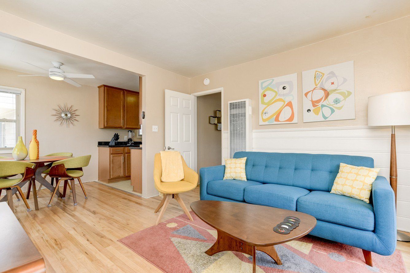 A living room with a blue couch and a coffee table.