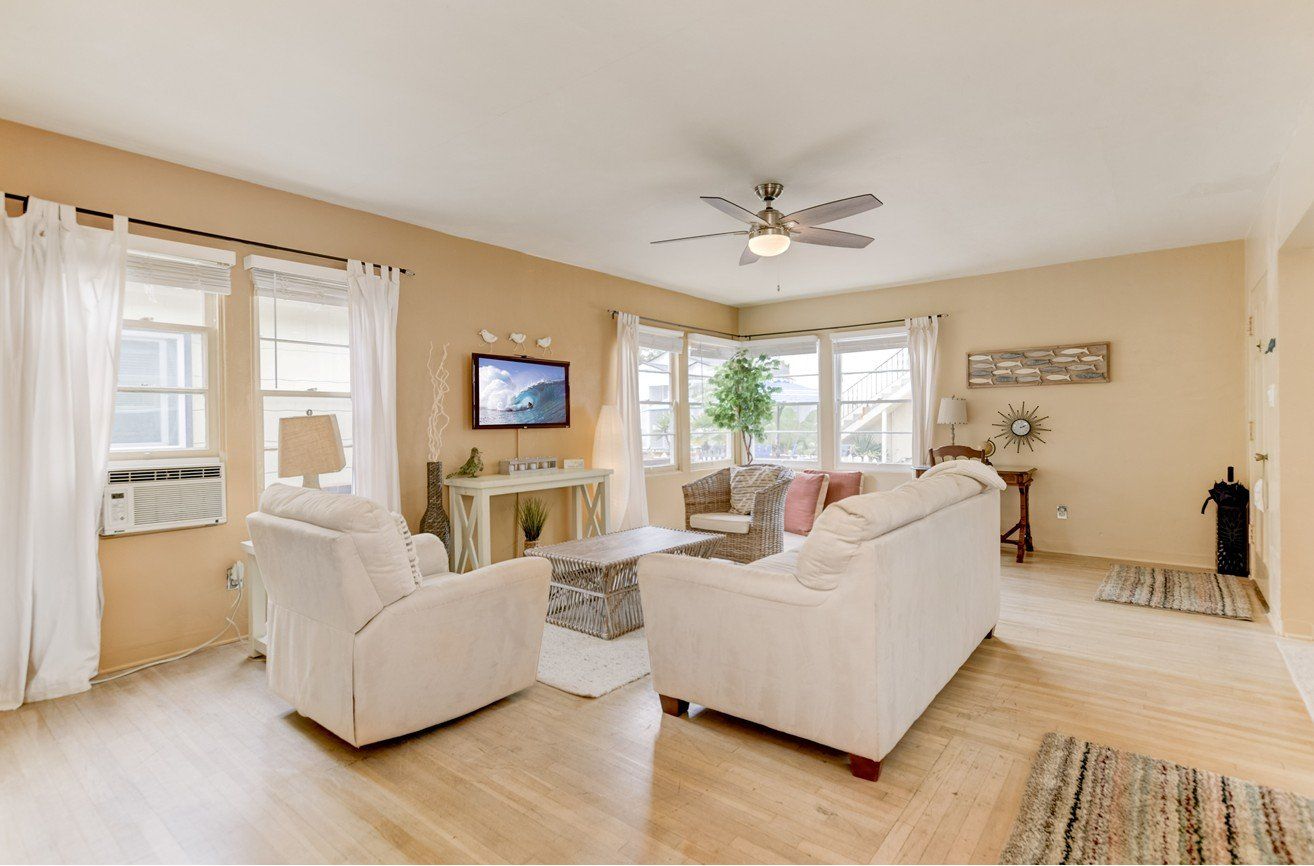 a living room filled with furniture and a flat screen tv .