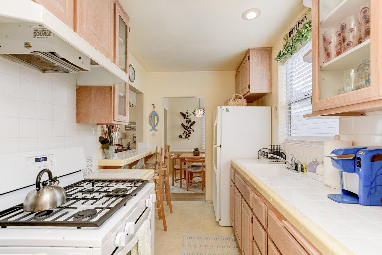 a kitchen with a stove top oven and a refrigerator