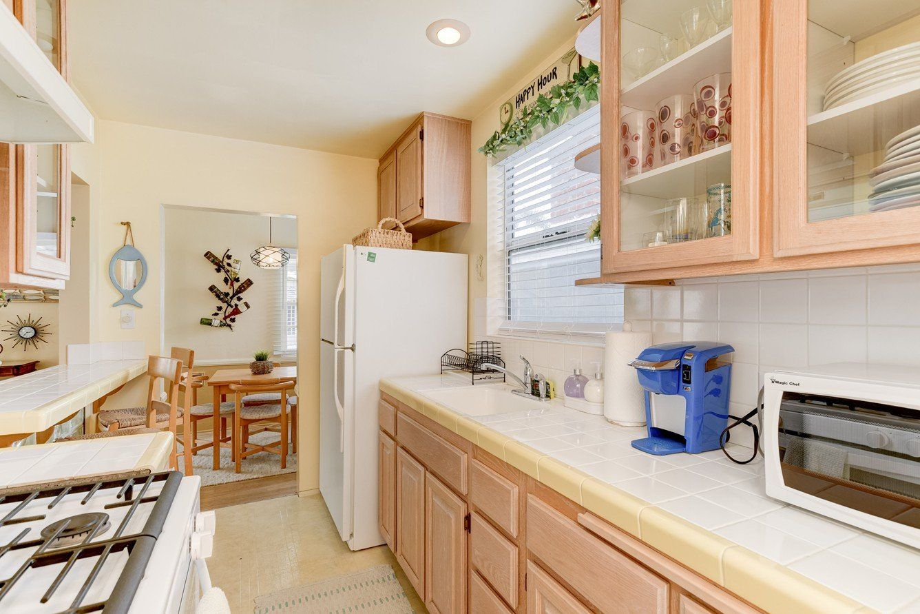 a kitchen with a refrigerator , stove , microwave , and sink .