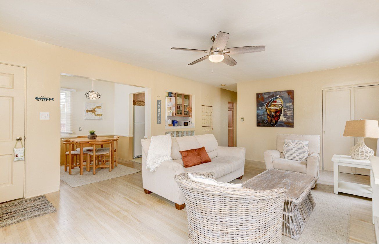 a living room filled with furniture and a ceiling fan .