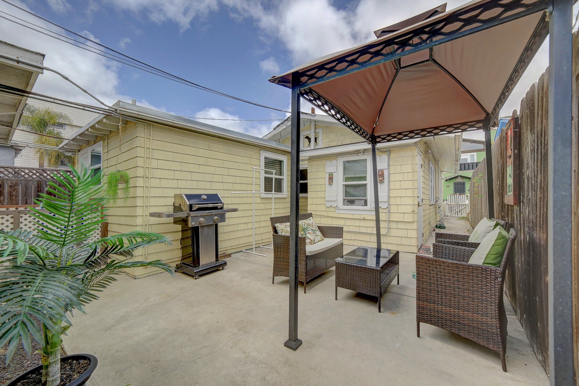 there is a gazebo in the backyard of a house .
