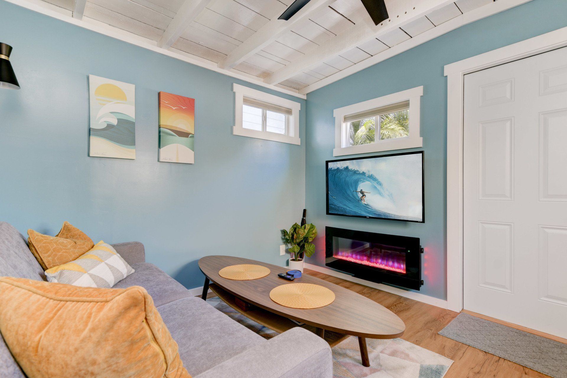 a living room with a couch , table , fireplace and television .