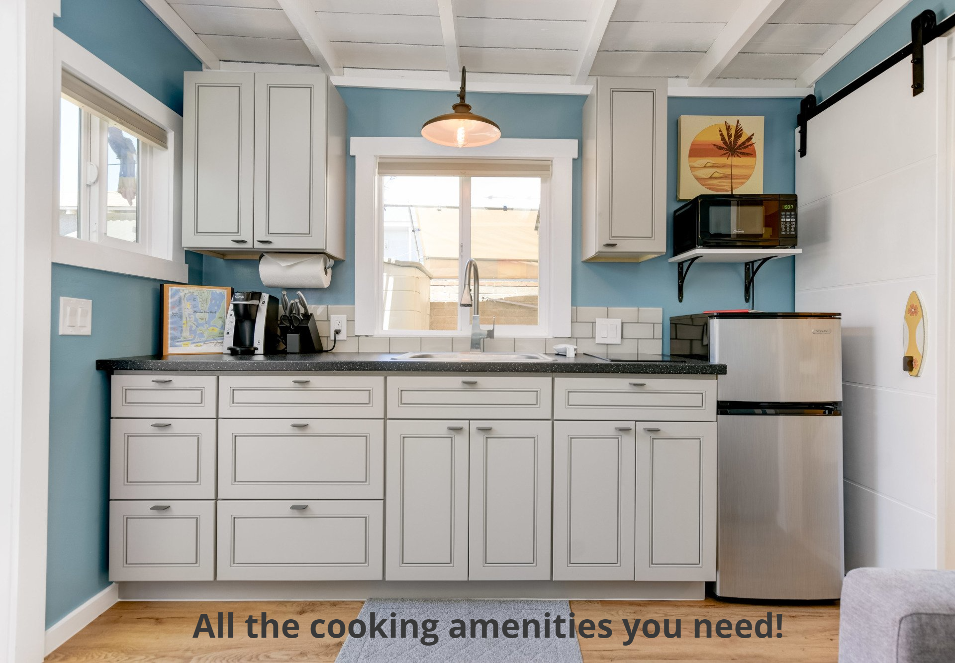 a kitchen with white cabinets and a stainless steel refrigerator .