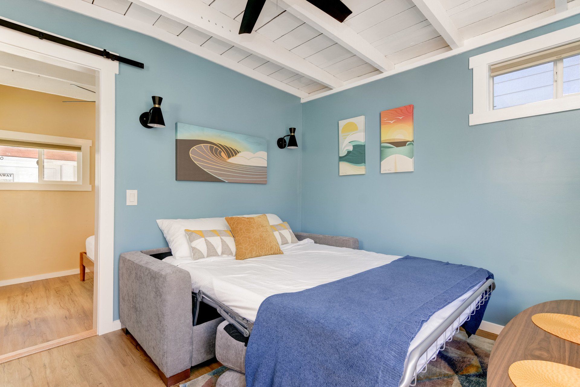 a bedroom with a couch that has been converted into a bed .