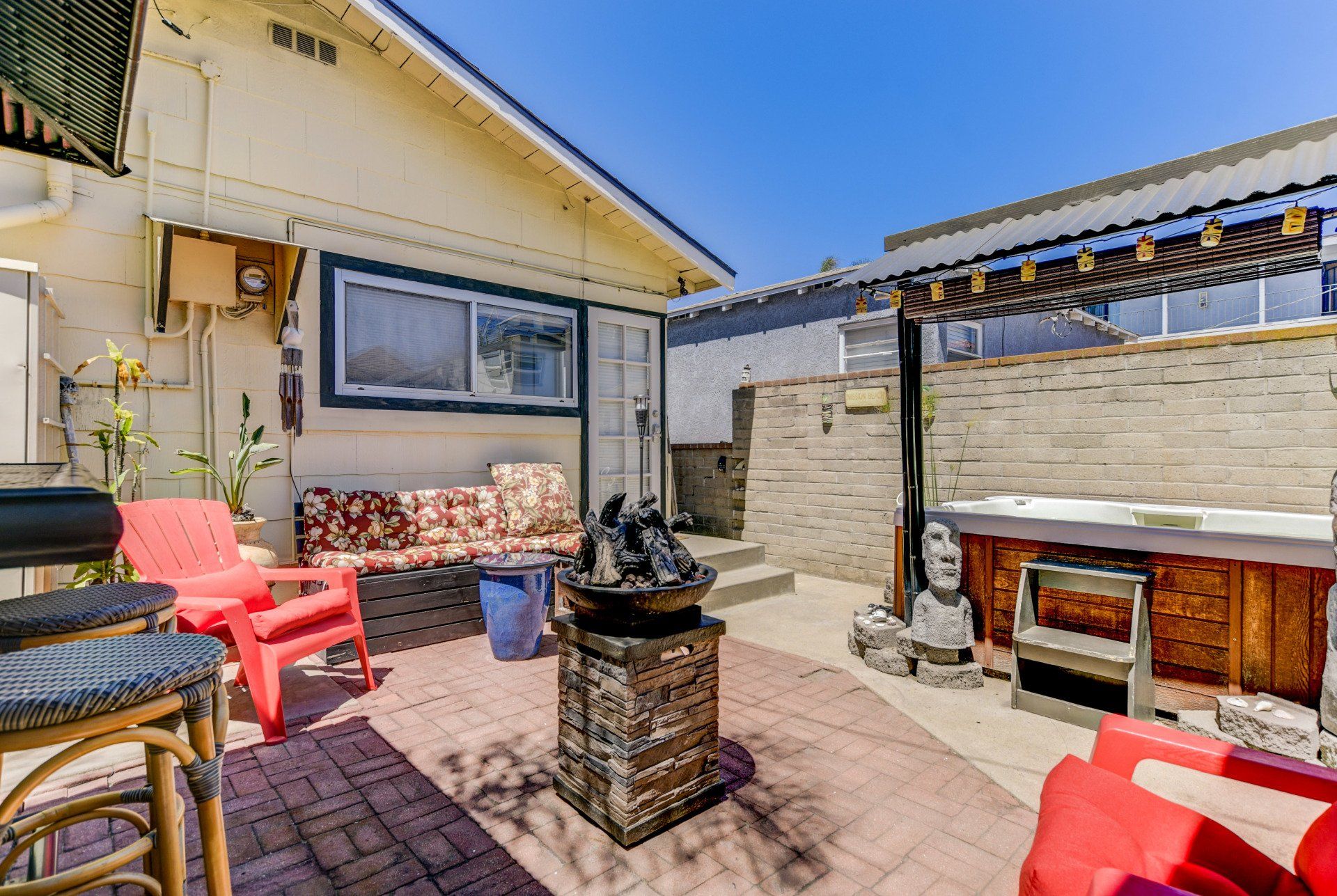 there is a hot tub in the backyard of a house .