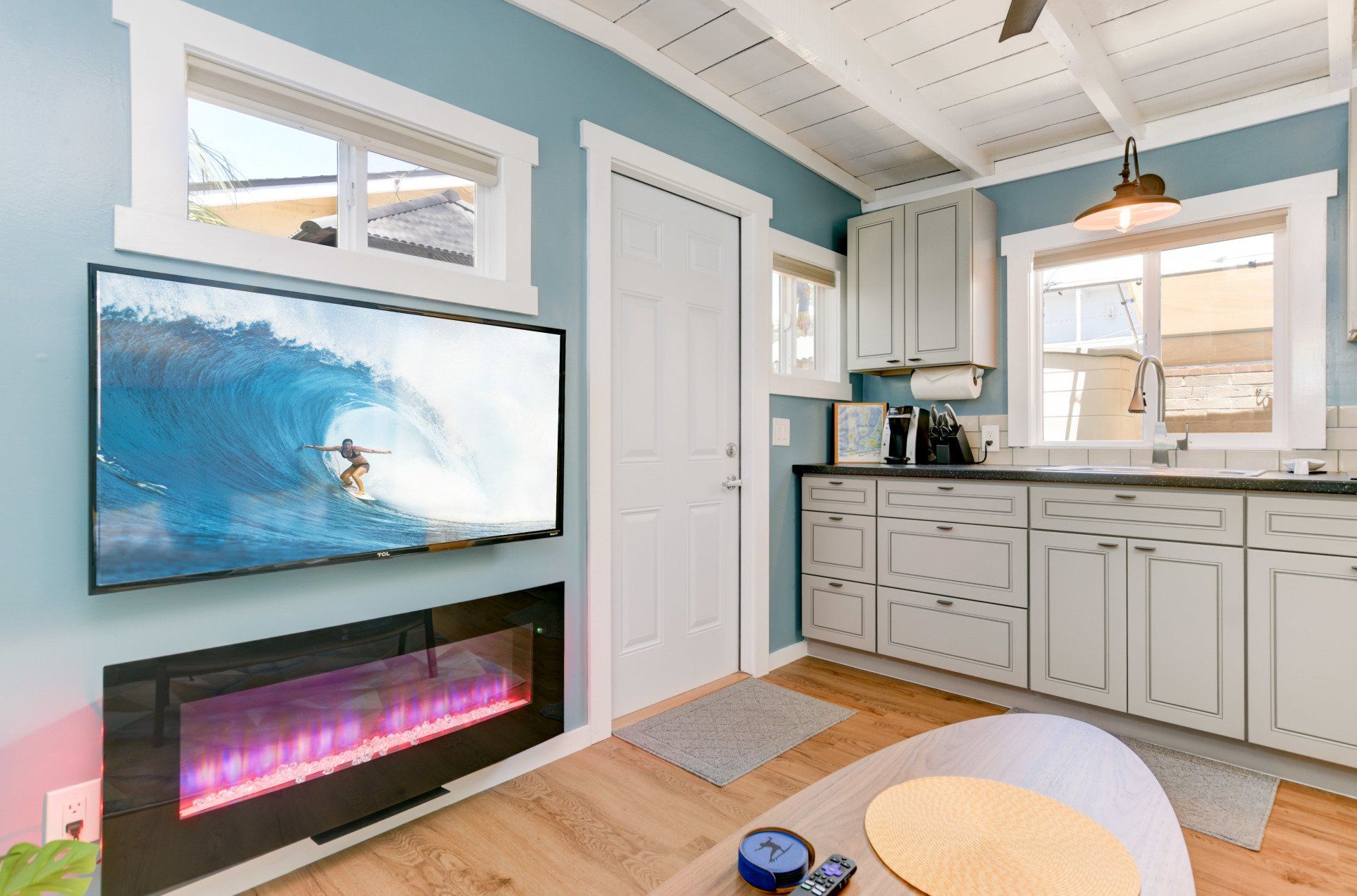 a living room with a fireplace and a flat screen tv .