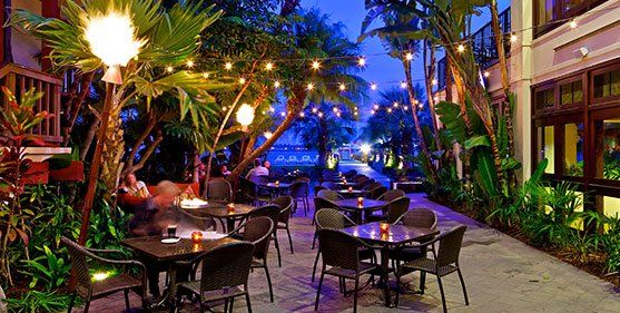 a restaurant with tables and chairs outside at night .