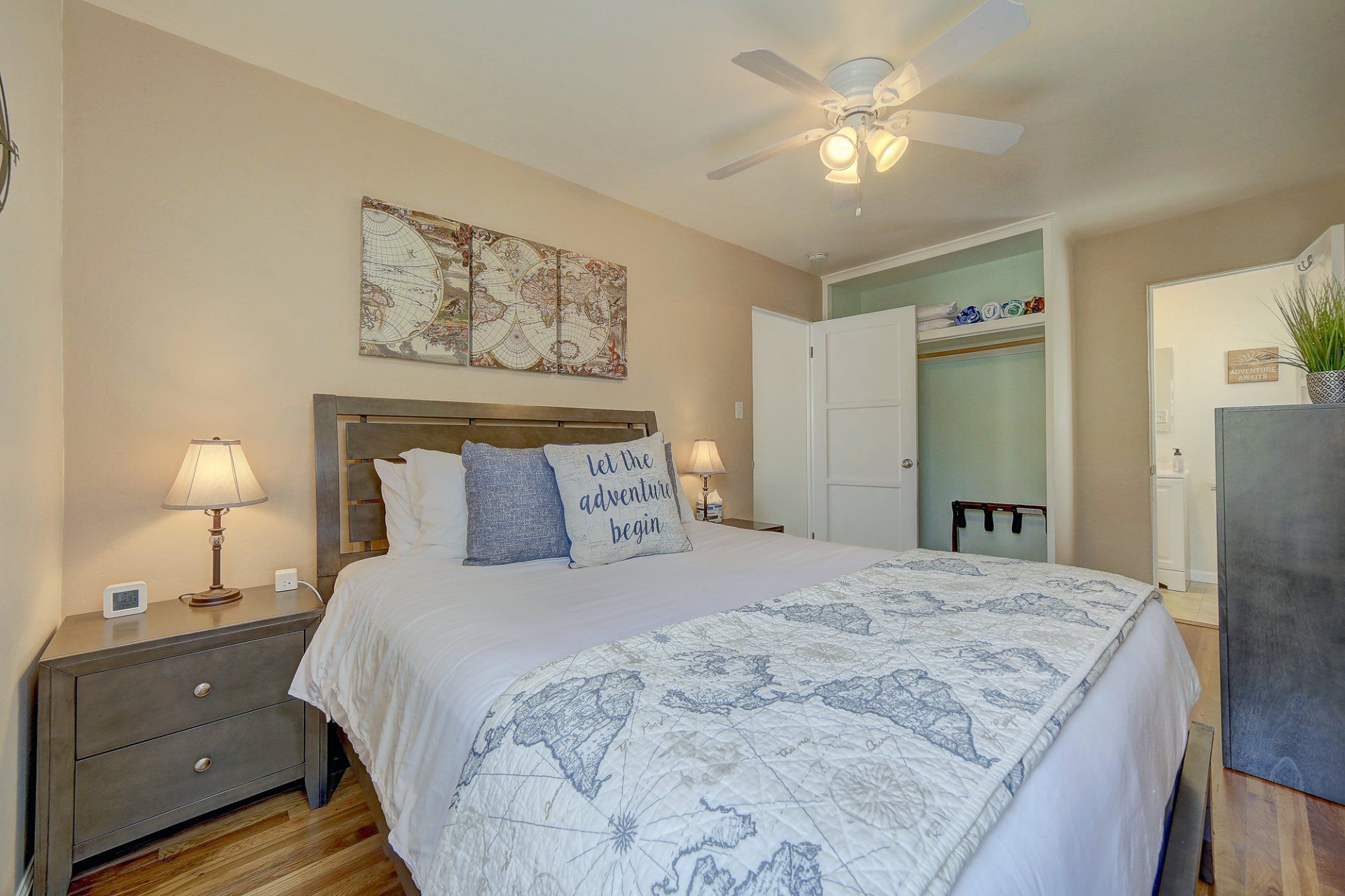 A bedroom with a king size bed and a ceiling fan.