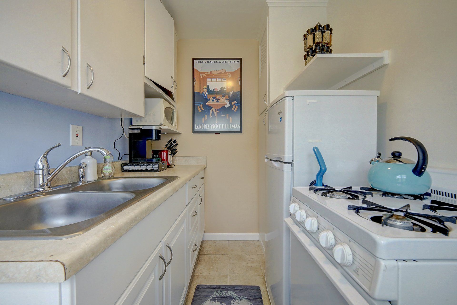 a kitchen with a stove , sink and refrigerator