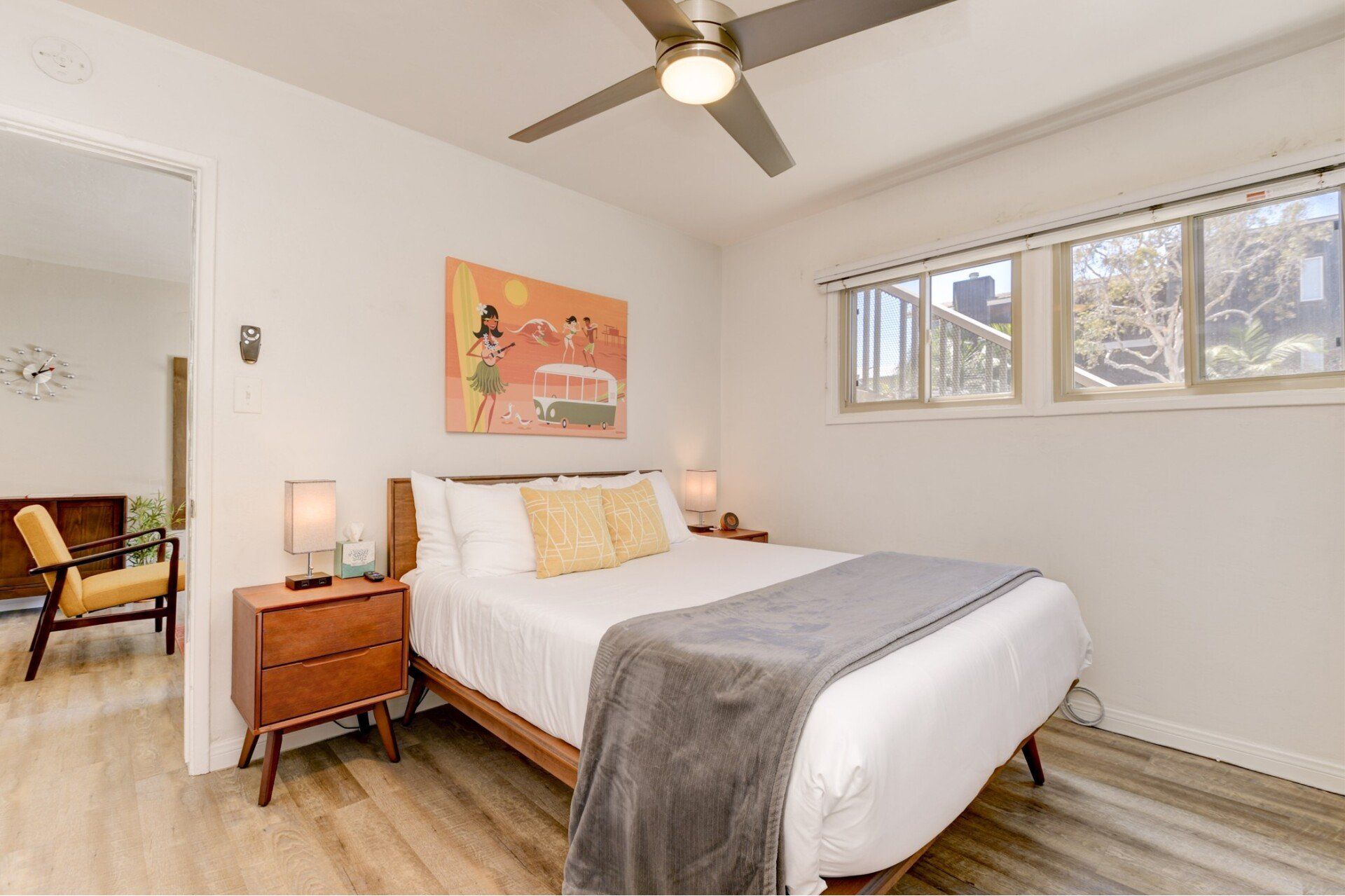 a bedroom with a bed , nightstand , and ceiling fan .