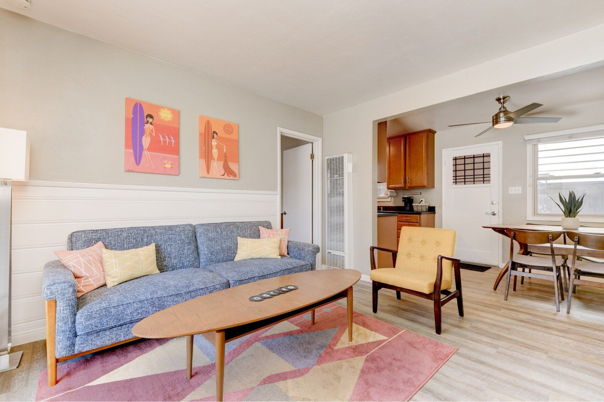 a living room with a blue couch and a coffee table .