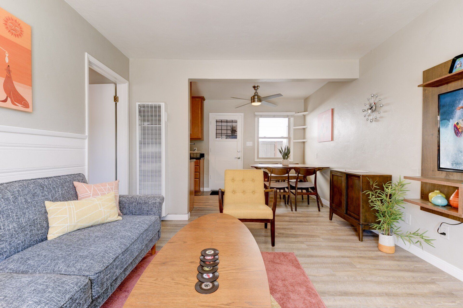 a living room with a couch , table , chairs and a television .