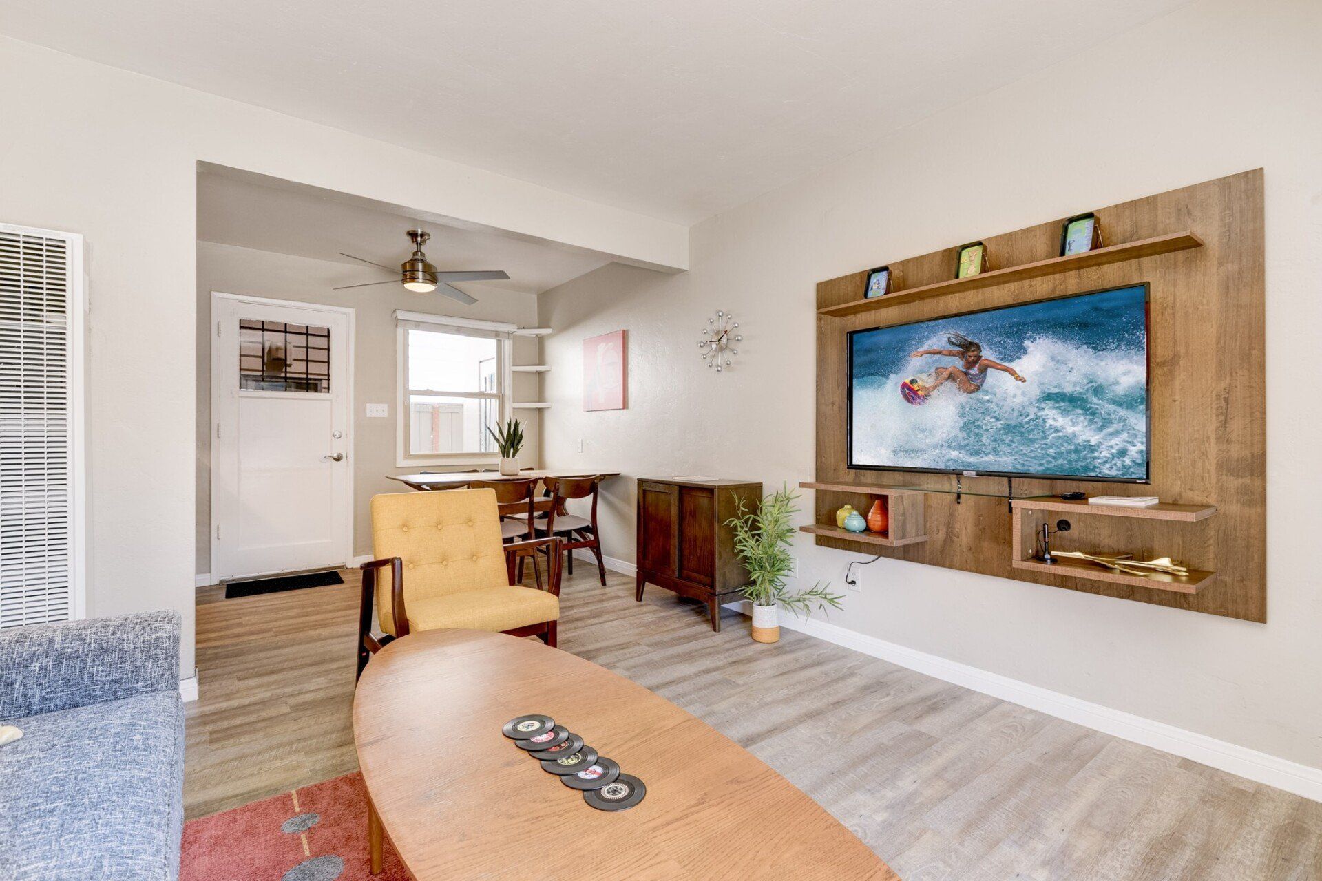 a living room with a flat screen tv mounted on the wall .