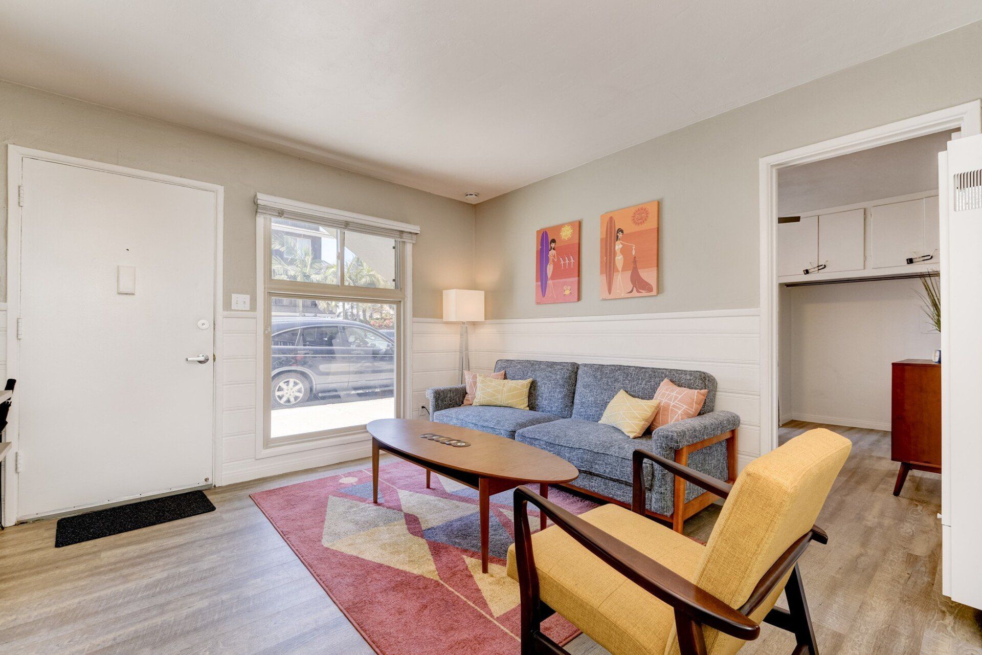 a living room with a couch , chairs , and a coffee table .