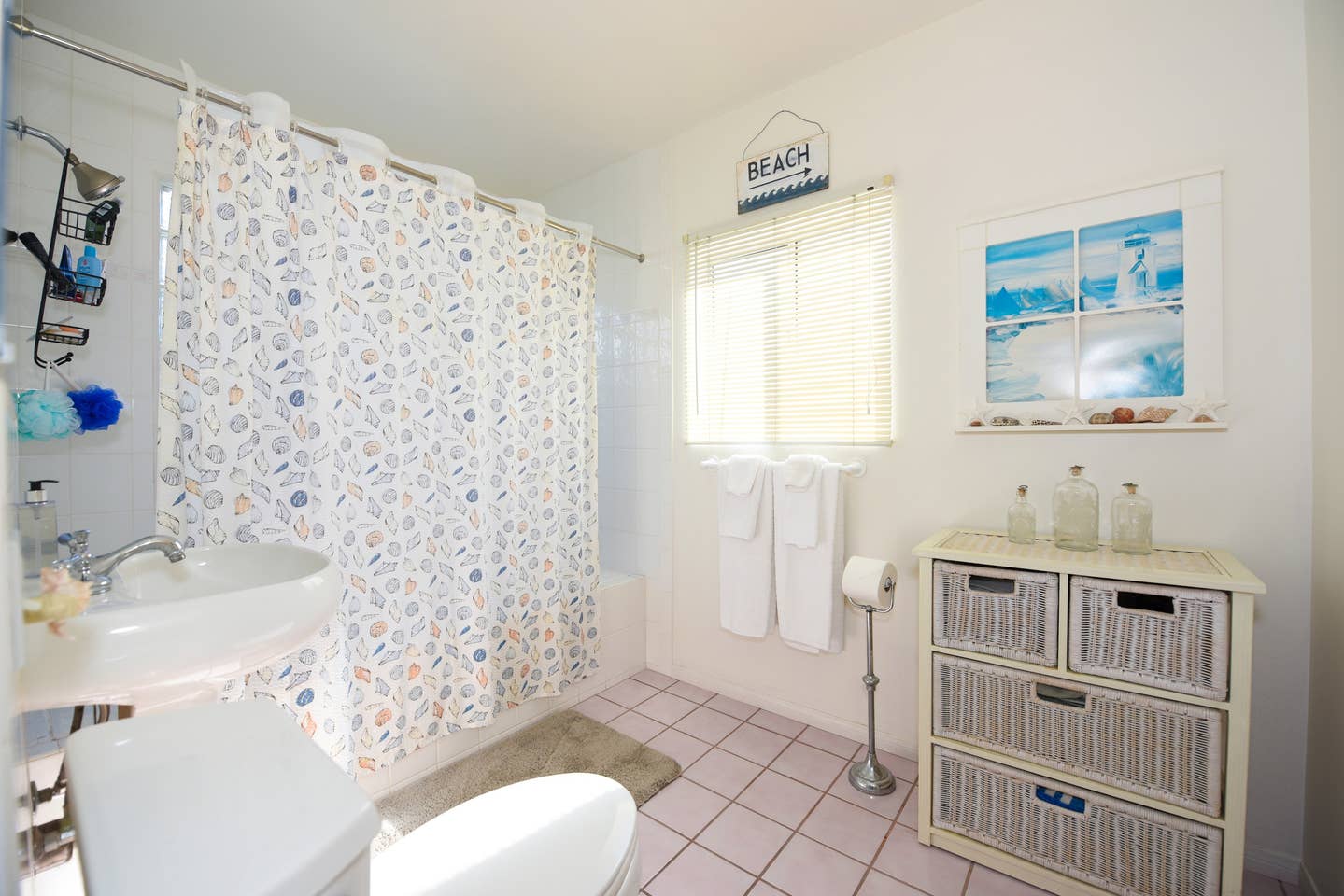 a bathroom with a toilet , sink and shower curtain