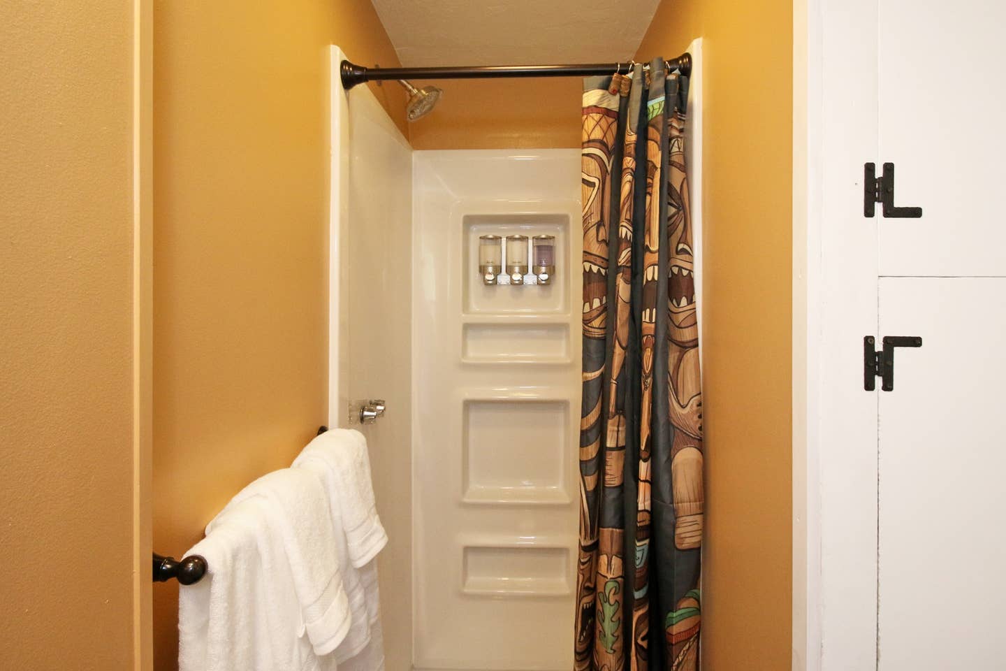 a bathroom with a shower curtain and a towel rack
